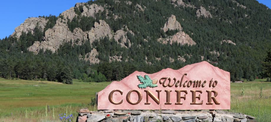 A sign reading "Welcome to Conifer."
