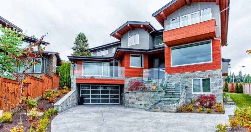 A beautiful custom-built glass garage door on a modern luxury home.