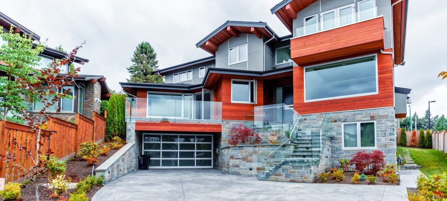 A beautiful custom-built glass garage door on a modern luxury home.