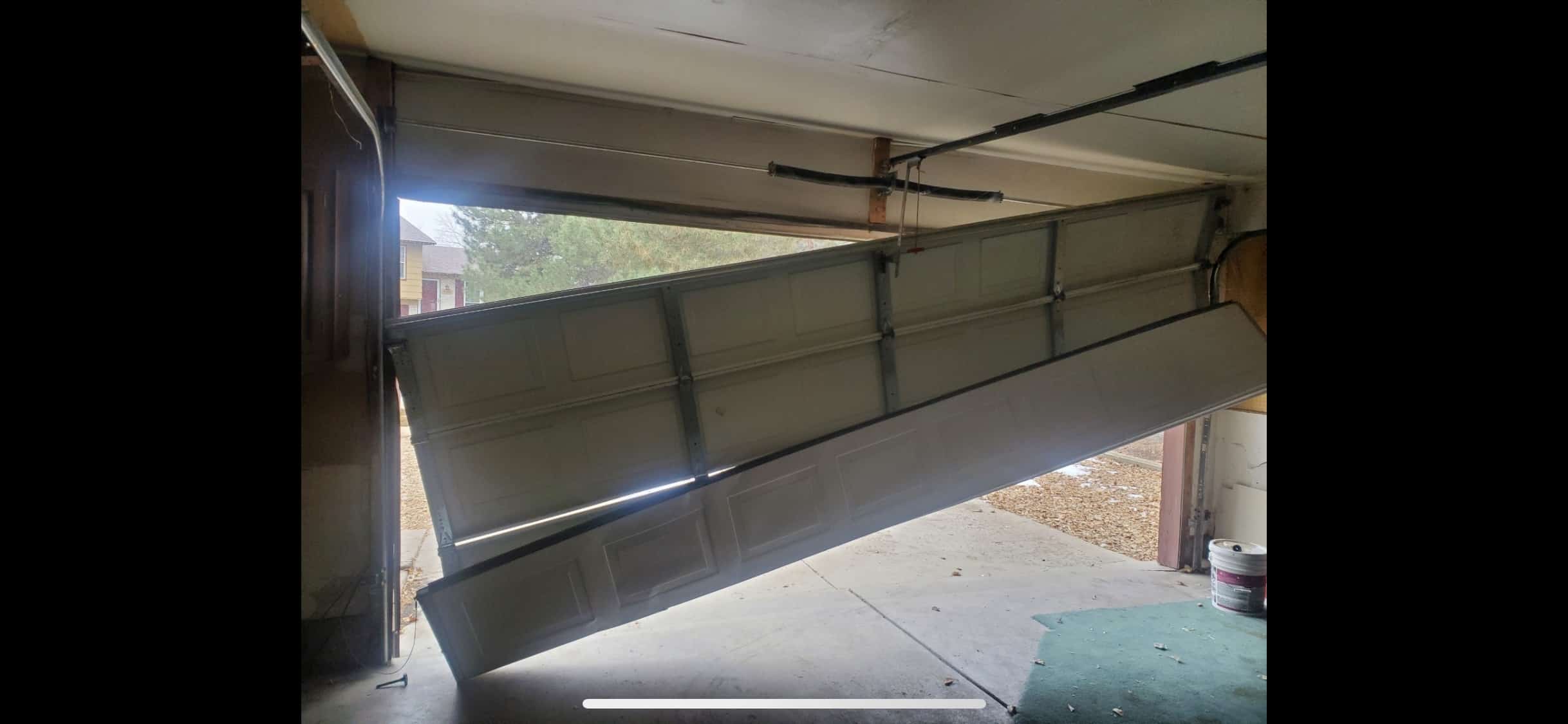 A severely damaged garage door